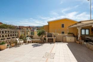 Large seaside apartment with patio in Lu Bagnu Apartment in Sardinia