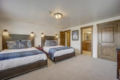 Second bedroom featuring a queen sized bed and twin bed, ample closet space, and an ensuite bath.