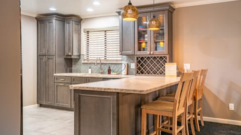 Kitchen's barstool seating with pendant lighting.