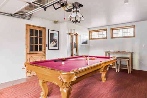 Game room complete with a billiards table.
