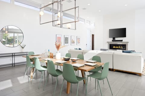 Poolside patio features an outdoor living area and a covered dining table.