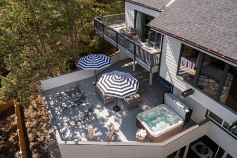 Multiple spacious decks with fire pit, dining, ping pong, and all-around lounging.