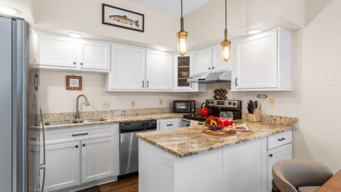 Bright, fully equipped kitchen with granite counters—perfect for relaxed mountain-side cooking.