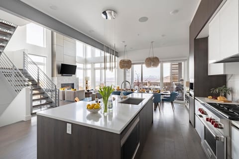 Kitchen features an island with countertop stool seating.