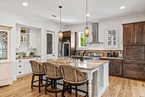 Chef's dream kitchen features modern appliances and an island with counter-top stool seating.
