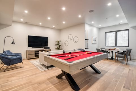 The rec room downstairs features a pool table, sitting area, and table perfect for eating or games.