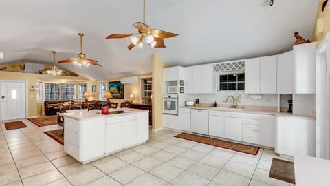 Spacious open layout with a bright kitchen, vaulted ceilings, and a cozy living area for gathering.