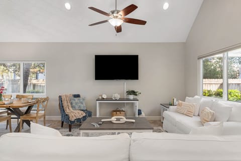 Living room features two couches and a TV.