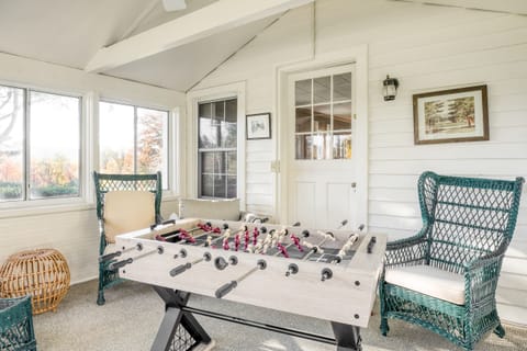Screened porch with a foosball table.