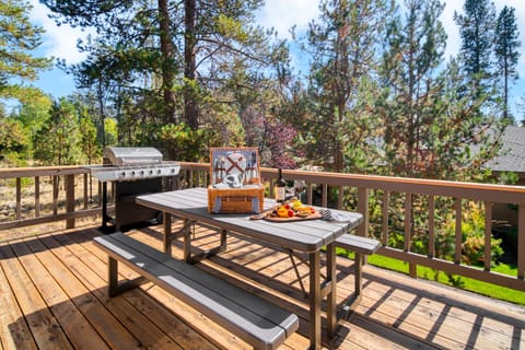 Outdoor dining table and BBQ grills for open-air meals.