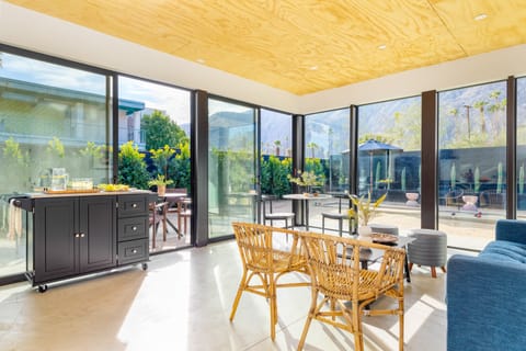 Bright living and kitchen area with floor-to-ceiling windows.