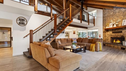 Vaulted ceilings, open design, and a living room fireplace.