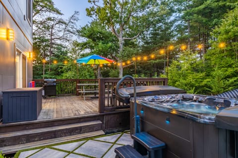 Private oasis with BBQ grill, outdoor dining, and hot tub.