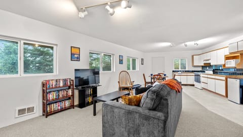 The primary living room features comfortable seating and a TV for your entertainment.