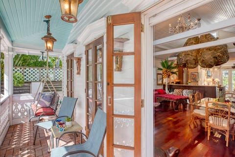 Covered balcony is accessible through the living room. (Main House)