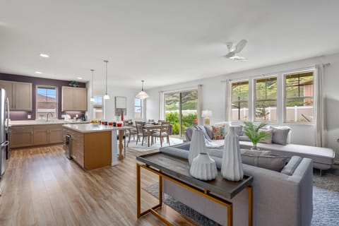 Fully equipped kitchen with modern appliances and barstool seating.