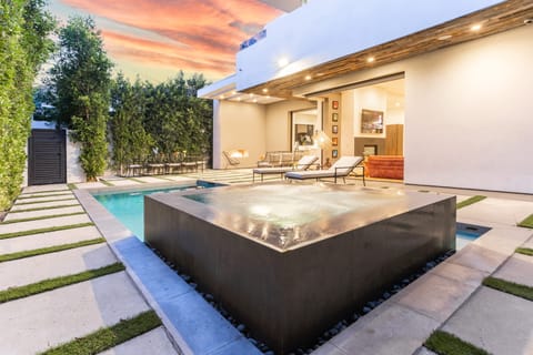 Backyard features a pool, jacuzzi, and multiple sitting areas.