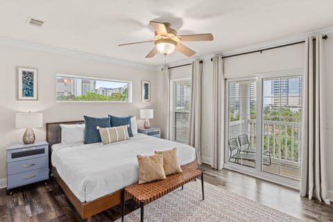 Primary bedroom features a king bed, balcony, TV, and ensuite bathroom.