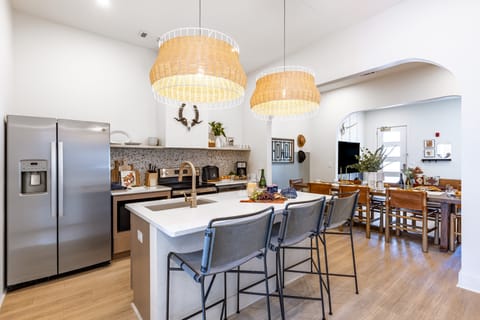 Fully equipped kitchen with an island counter and barstool seating.