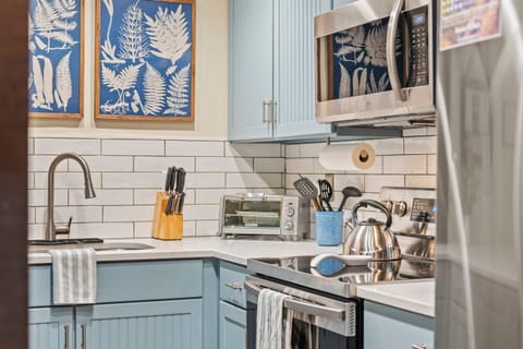 Kitchen with modern appliances, blue cabinets, and ample counter space