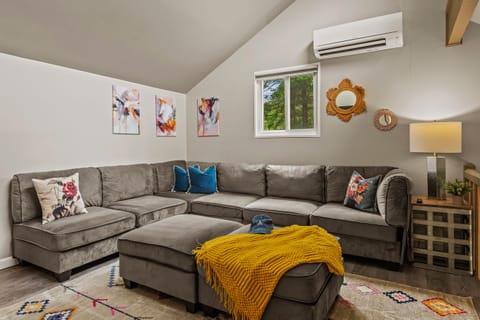 Secondary lounge with a large sectional sofa.