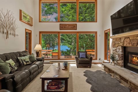 Lake views through floor-to-ceiling windows in the living room.