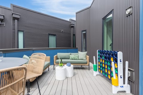 Outdoor space with seating, an al fresco dining area, and Giant Connect 4.