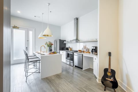 Fully equipped kitchen with a large island and barstool seating.