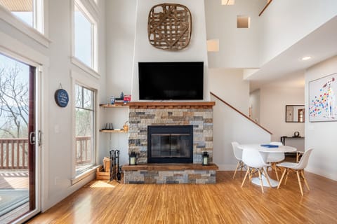 Spacious living room with a fireplace and large TV.