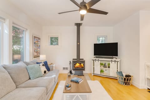Bright and chic living room featuring a fireplace and a TV.