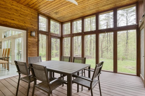 The sunroom dining table offers additional seating for guests.