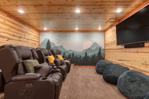 Theater room with comfy chairs for a perfect movie night.