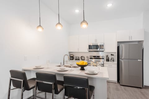 Fully equipped kitchen with barstool seating.