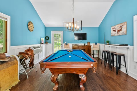 Rack 'em up and enjoy a friendly game on the sleek pool table.