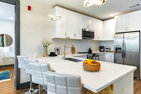 Fully equipped kitchen with barstool seating.