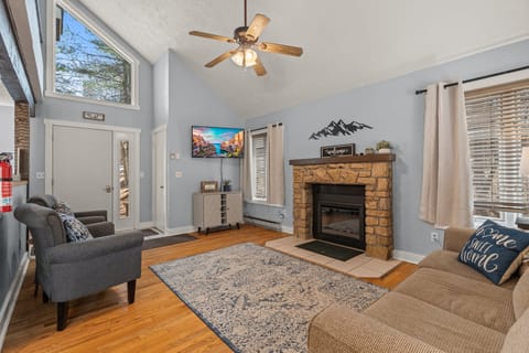 Living area features a cozy fireplace and TV.