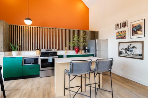Stylish kitchen boasts vibrant pops of color.