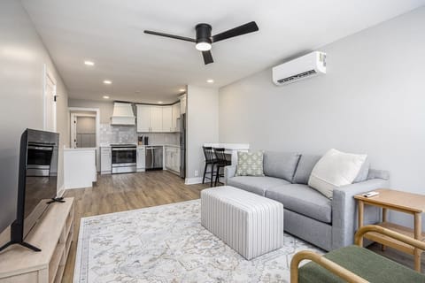 The living room features a sleeper sofa.