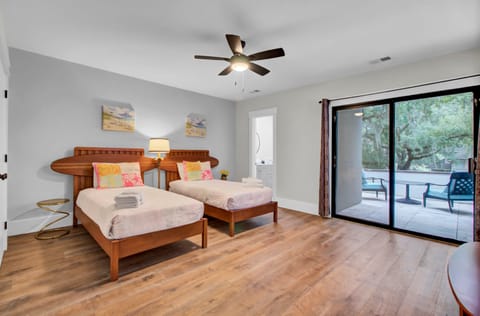 Bedroom 3 features two twin beds, an ensuite bathroom, and a patio.