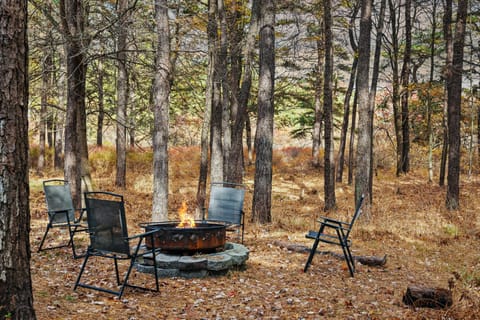 Firepit surrounded by trees.
