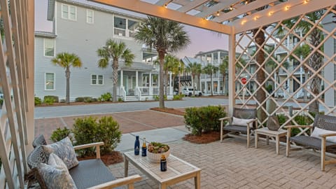 Private patio with a pergola, BBQ grill, and outdoor seating.