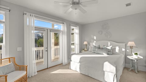 Spacious primary suite with French doors leading to a balcony.