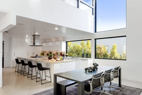 Floor-to-ceiling windows near the dining area and kitchen.