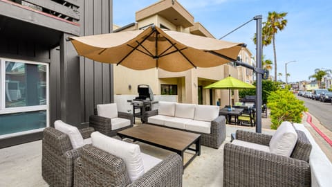 Shaded outdoor lounge with plenty of seating, perfect for morning coffee, casual meals, or unwinding after a beach day.