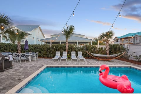 Enjoy the pool area complete with loungers, a BBQ grill, and fun pool floats for endless relaxation and entertainment.
