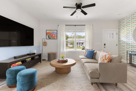 Kick back and relax in this spacious living room with large screen TV.