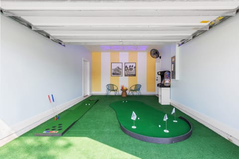 Level up your mini-golf game with the putting green area in the garage.