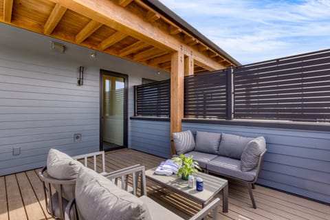 Private deck with hot tub and seating.