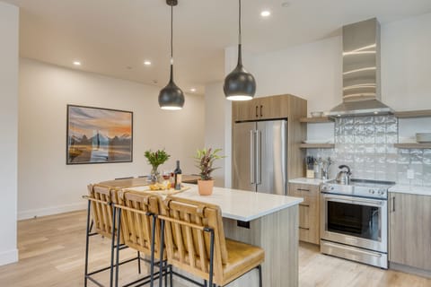 Modern kitchen with waterfall island and stylish bar seating.