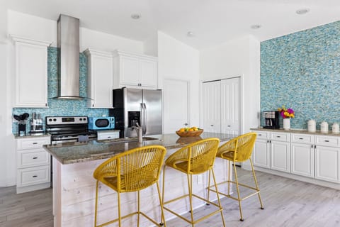 Fully stocked kitchen with barstool seating.